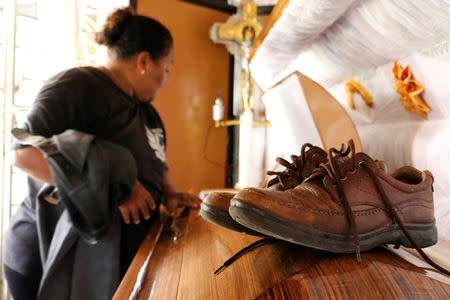 A pair of shoes of reporter Candido Rios, gunned down by unknown assailants, are seen over his coffin during his wake at his home in Hueyapan de Ocampo, in Veracruz state, Mexico, August 23, 2017. REUTERS/Victor Yanez