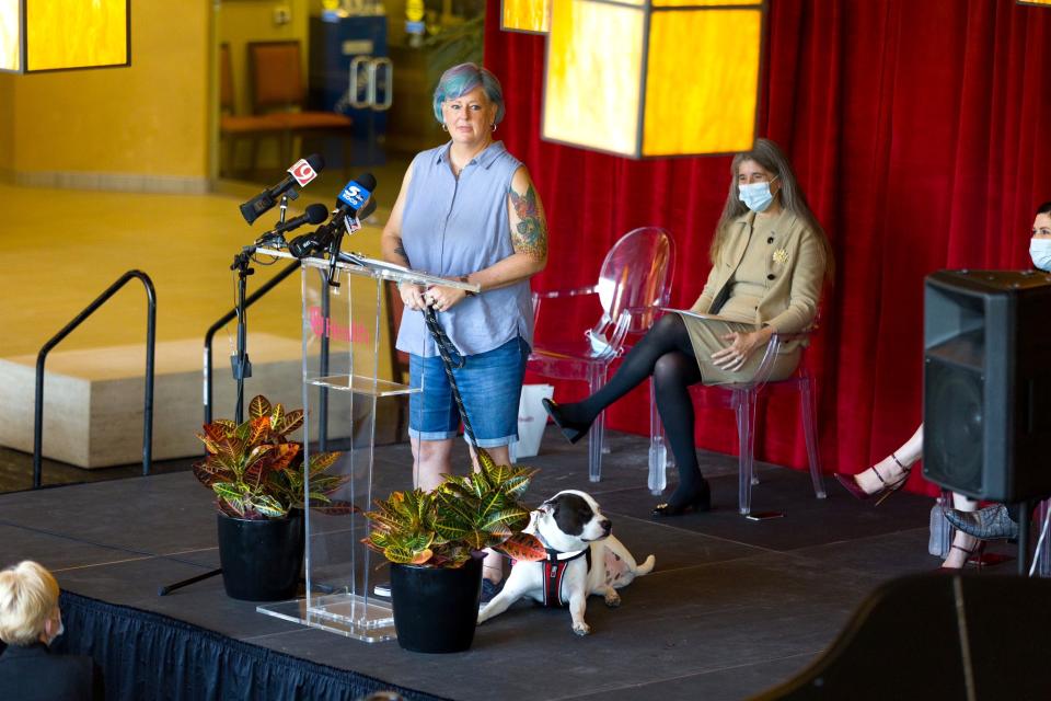 Dena Newlun, an OU Health Stephenson Cancer Center patient, speaks with her therapy dog, Tripod Petey, by her side.