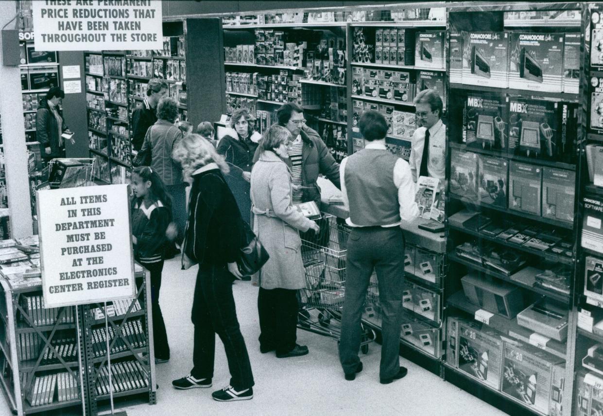 Children’s Palace salesman Dan Kasburg waits on customers in 1983 at the Romig Road store at Rolling Acres in Akron.
