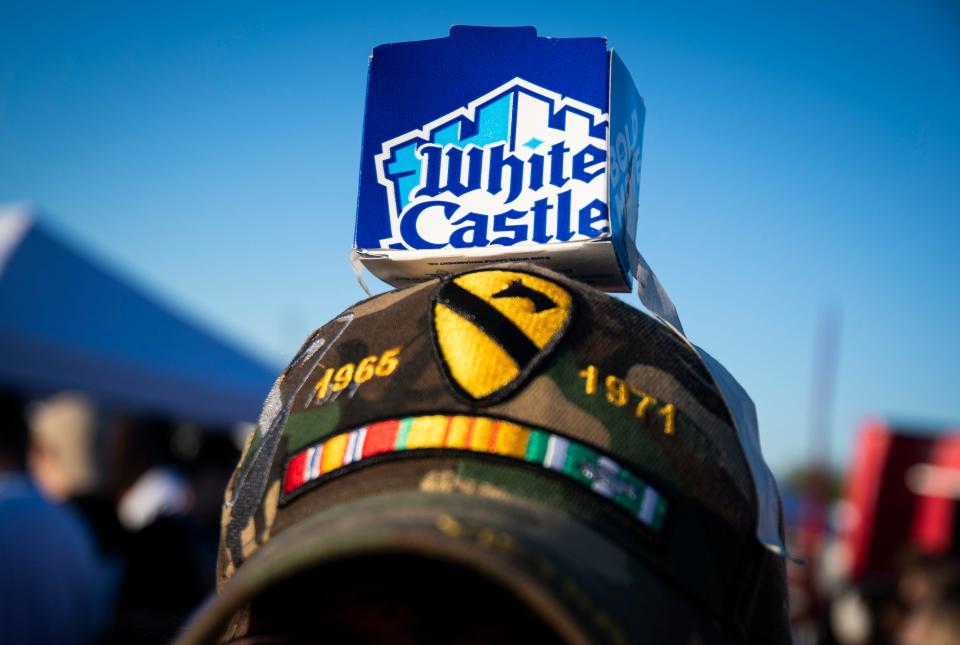 A man dons a makeshift White Castle hat at the opening of the first White Castle in Arizona in the Talking Stick Entertainment District near Scottsdale on Oct. 23, 2019.