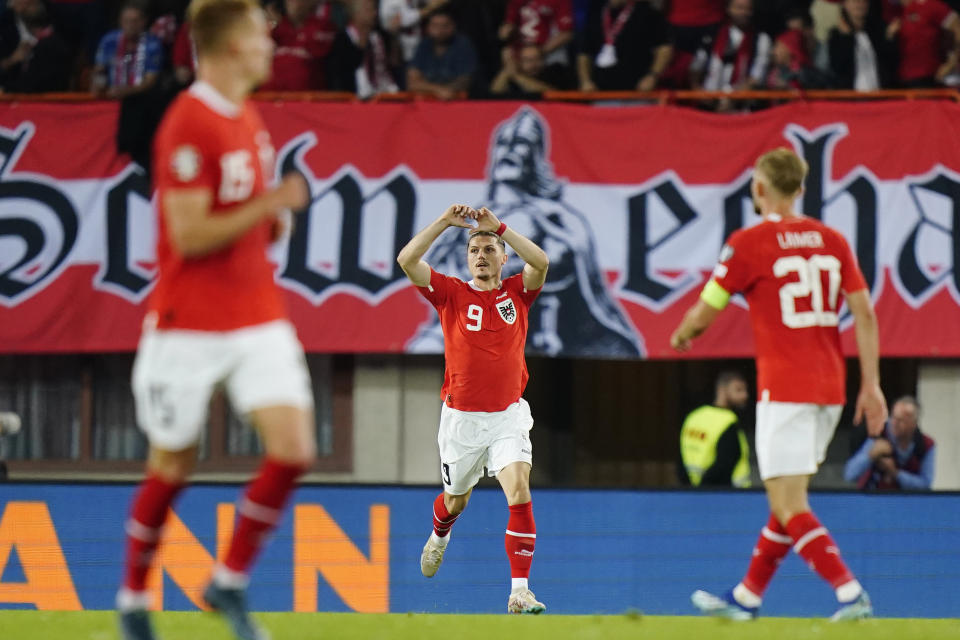 Austria's Marcel Sabitzer, centre, celebrates after scoring his side's second goal during the Euro 2024 group F qualifying soccer match between Austria and Belgium at the Ernst Happel stadium in Vienna, Austria, Friday, Oct. 13, 2023. (AP Photo/Florian Schroetter)