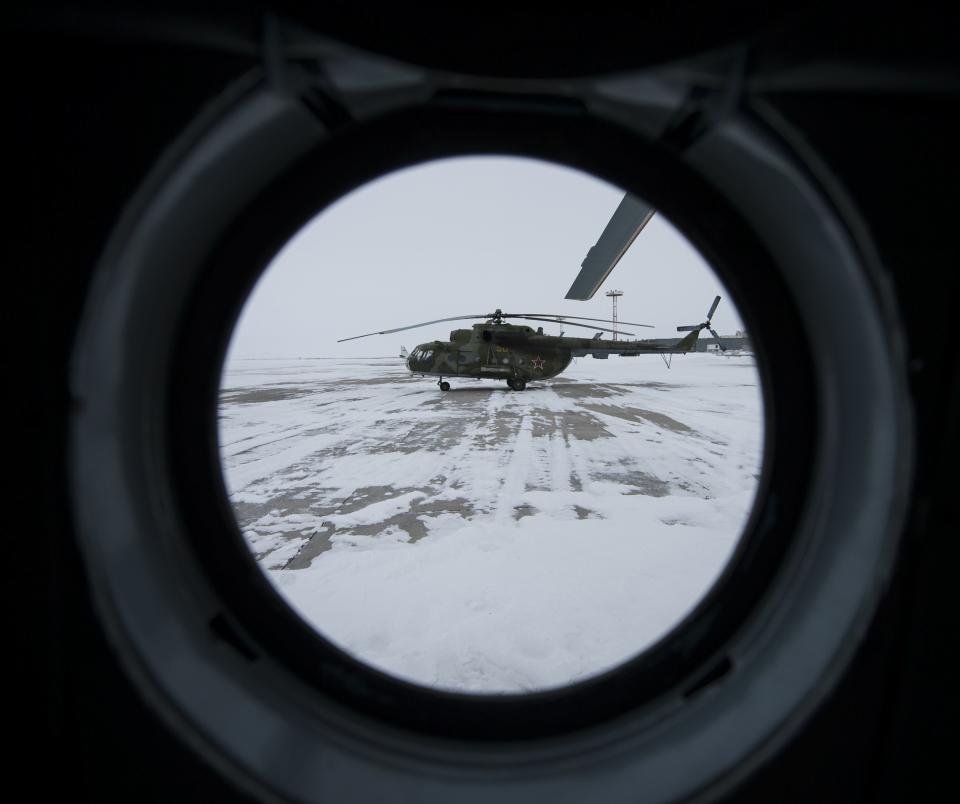 A Russian MI-8 helicopter is seen through the window of another helicopter at the Karanganda airport, March 10, 2014. (REUTERS/Bill Ingalls/NASA/Handout via Reuters)