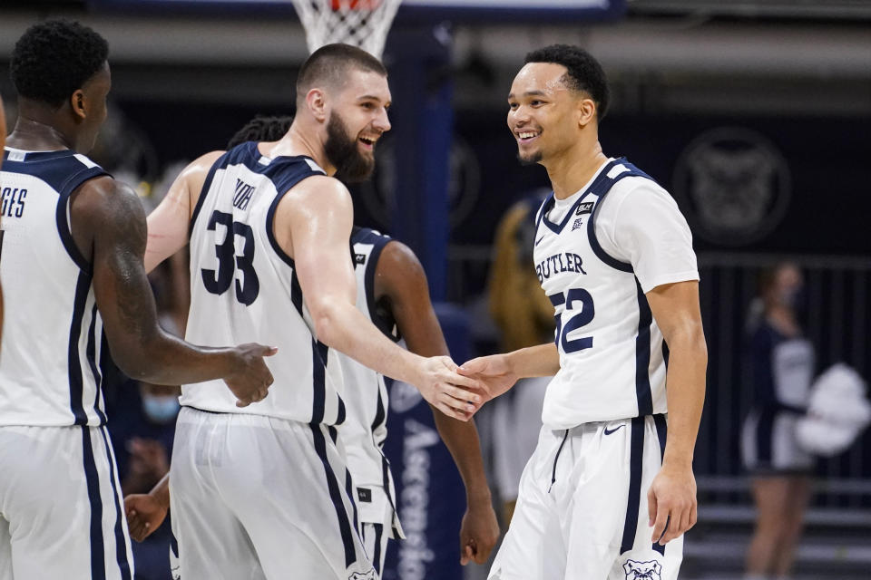 Butler guard Jair Bolden (52) celebrates after a three-point basket with forward Bryce Golden (33) in the second half of an NCAA college basketball game against Villanova in Indianapolis, Sunday, Feb. 28, 2021. (AP Photo/Michael Conroy)