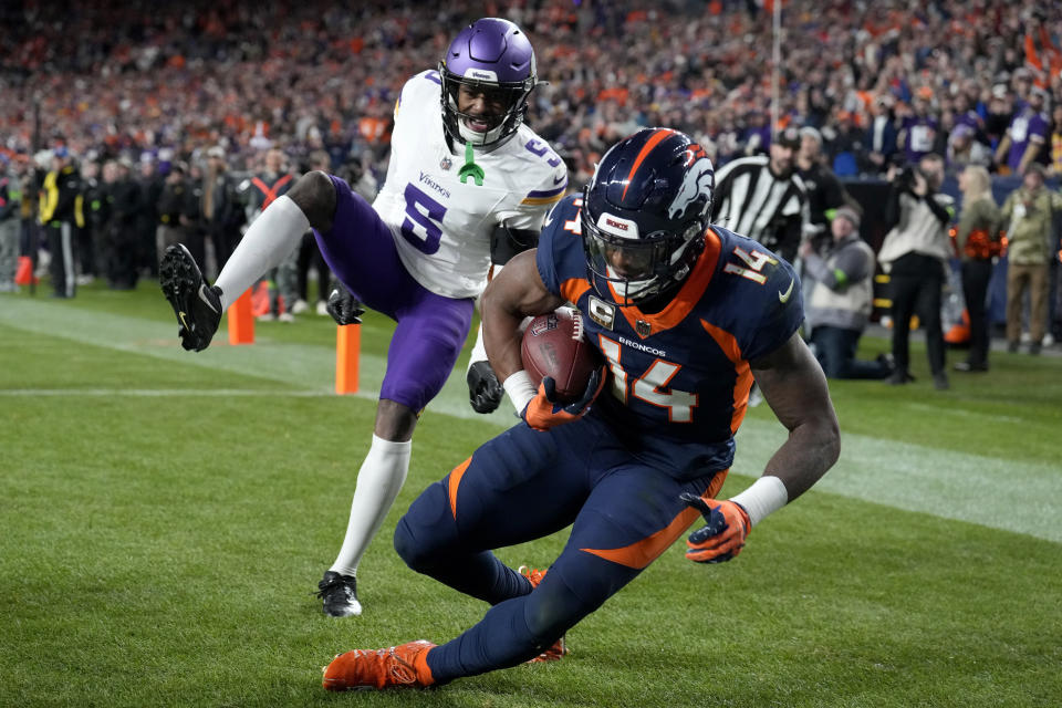 Denver Broncos wide receiver Courtland Sutton (14) pulls in a touchdown as Minnesota Vikings cornerback Mekhi Blackmon (5) defends during the second half on an NFL football game, Sunday, Nov. 19, 2023, in Denver. (AP Photo/David Zalubowski)