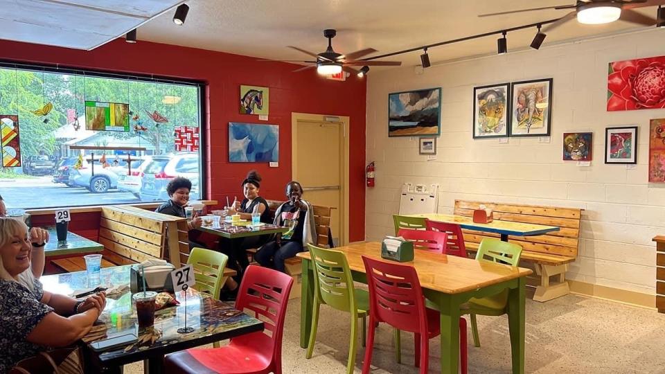 Customers sit inside of the new SweetBerries located at 619 NW 5th Avenue.