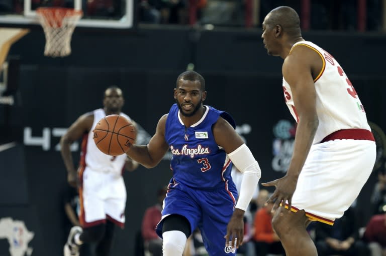 NBA Team World's US captain Chris Paul (R) of the Los Angeles Clippers dribbles the ball during the NBA Africa basketball match between Team Africa and Team World on August 1, 2015, in Johannesburg