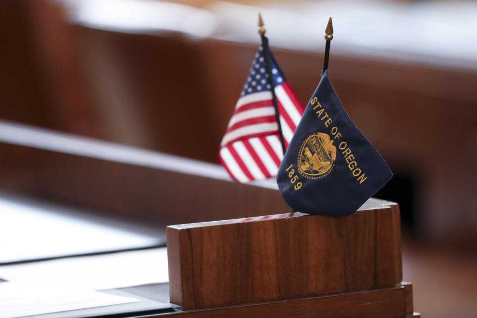 Flags sit on a desk belonging Republican state Sen. Lynn Findley in the Oregon Senate prior to a legislative session at the Oregon State Capitol in Salem, Ore., Friday, May 5, 2023. Sen. Findley, along with three other Republican senators and one Independent senator had unexcused absences during two prior sessions, preventing a quorum. (AP Photo/Amanda Loman)