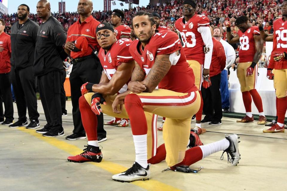 Colin Kaepernick (right) and Eric Reid of the San Francisco 49ers kneel in protest during the national anthem (Getty Images)