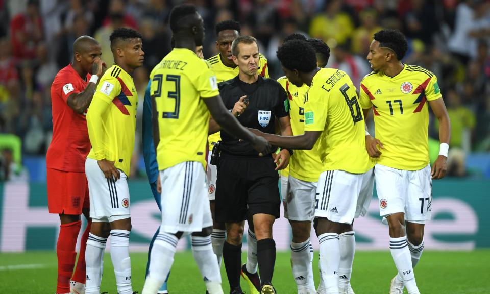 Colombia players confront referee Mark Geiger after he awarded England a penalty on Tuesday in a game that contained moments of play-acting from players on both sides.