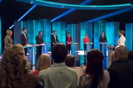 (L-R) Natalie Louise Bennett the leader of the Green Party, Nick Clegg the leader of the Liberal Democrats, Nigel Farage the leader UKIP, Ed Miliband the leader of the Labour Party, Leanne Wood the leader of Plaid Cymru, Nicola Sturgeon the leader of the Scottish National Party (SNP) and David Cameron the leader of the Conservative Party and Britain's current prime minister stand during the leaders televised election debate at Media City in Salford in Northern England, in this April 2, 2015 handout provided by ITV. REUTERS/Ken McKay/ITV/Handout via Reuters