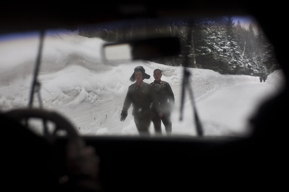 FILE - In this April 2, 2012, file photo, North Korean soldiers walk on a snowy mountain road at the base of Mount Paektu, North Korea near a secret camp that is said to have been the home of the late North Korean leader Kim Il Sung and the birthplace of his son and late leader Kim Jong Il. There is no more sacred a place in North Korea than Mount Paektu. The still active volcano, site of one the most violent eruptions in history, is considered to be the spiritual epicenter of the North Korean revolution. (AP Photo/David Guttenfelder, File)