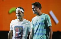 Canada's Milos Raonic (R) and Switzerland's Roger Federer react during a promotional event ahead of the Australian Open tennis tournament in Melbourne, Australia, January 14, 2017. REUTERS/Edgar Su