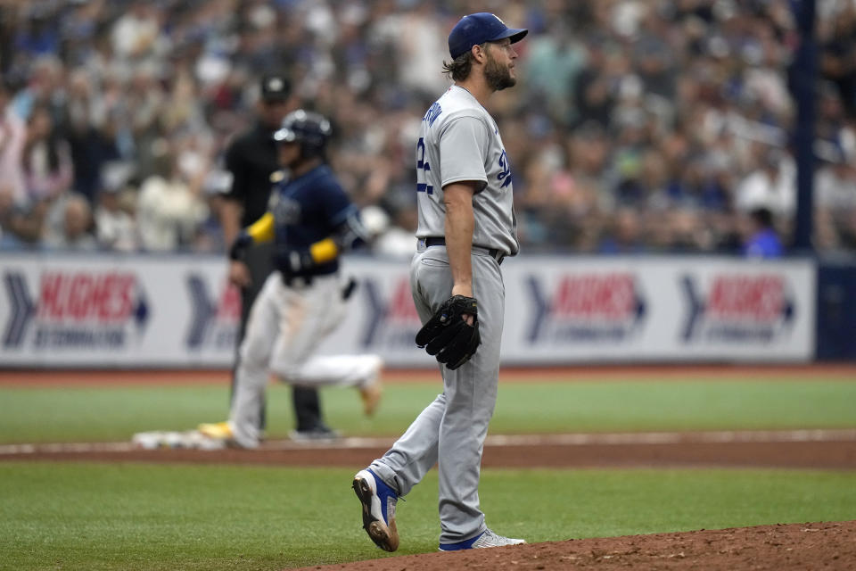 Los Angeles Dodgers starting pitcher Clayton Kershaw walks back to the mound as Tampa Bay Rays' Harold Ramirez runs around the bases after Ramirez hit a two-run home run during the fifth inning of a baseball game Saturday, May 27, 2023, in St. Petersburg, Fla. (AP Photo/Chris O'Meara)