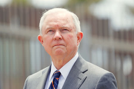 FILE PHOTO: U.S. Attorney General Jeff Sessions looks on during a news conference next to the U.S. Mexico border wall to discuss immigration enforcement actions of the Trump Administration near San Diego, California, U.S. May 7, 2018. REUTERS/Mike Blake/File Photo