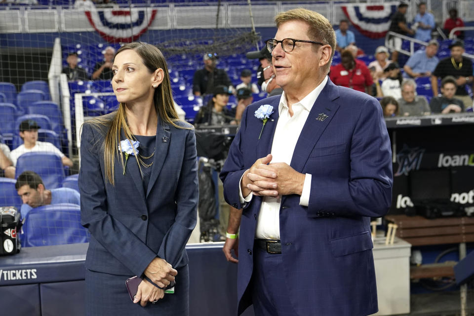 Caroline O'Connor, left, stands with chairman and principal owner Bruce Sherman before a baseball game against the Philadelphia Phillies, Thursday, April 14, 2022, in Miami. The Miami Marlins promoted O’Connor to president of business operations on Monday, Nov. 14, 2022 making them the first U.S. major sports franchise to have women as both president and general manager. The Marlins made history by hiring Kim Ng as GM in November 2020; two years later, they’ve now made another significant move. (AP Photo/Lynne Sladky)