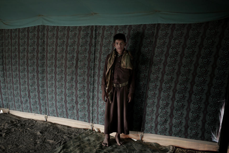 Nawaf, a 15-year-old former child soldier, poses for a photograph at a camp for displaced persons where he took shelter with his family, in Marib, Yemen, in this July 27, 2018, photo. He was forced to become a soldier by Houthi rebels after they arrested his father for allegedly helping the Saudi-led coalition. He was manning a checkpoint, searching vehicles, when an airstrike hit nearby, killing five of his friends. (AP Photo/Nariman El-Mofty)