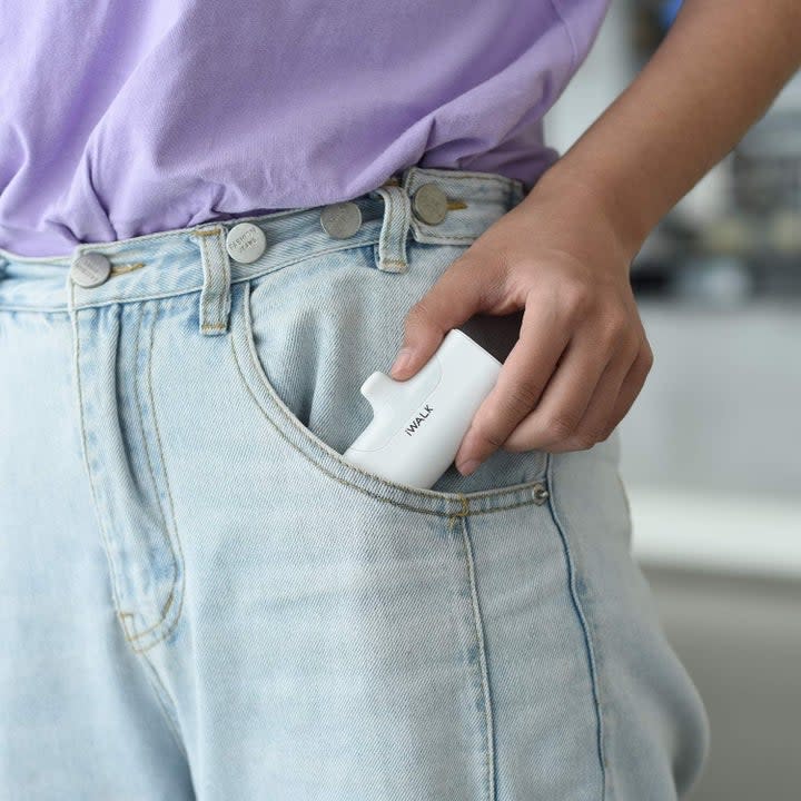 model putting the power bank in their pocket