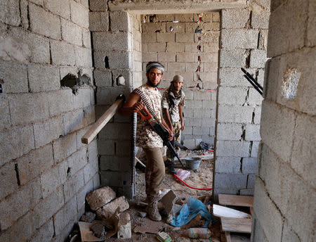 Fighters of Libyan forces allied with the U.N.-backed government stand in a house during a battle with IS fighters in Sirte. REUTERS/Goran Tomasevic