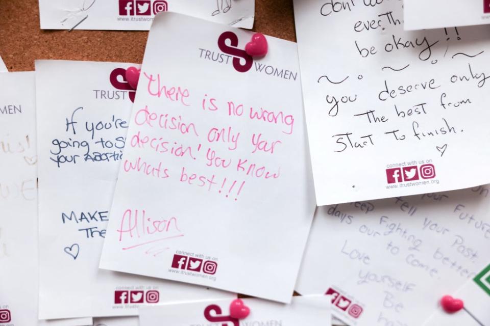 Handwritten notes of encouragement are pinned to the wall of a waiting room at the Trust Women clinic in Oklahoma City (Reuters)