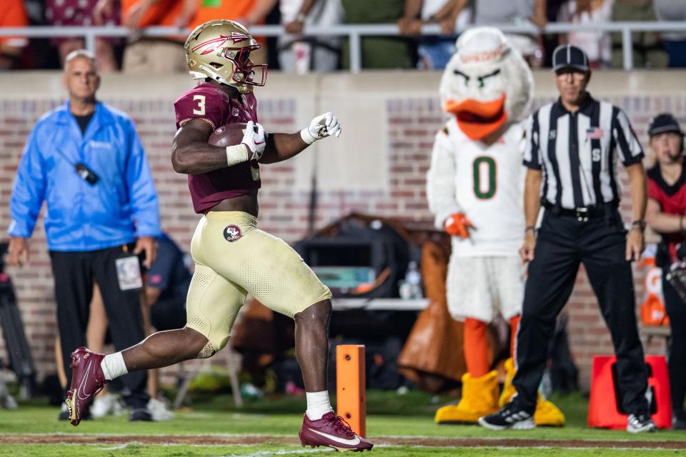 Florida State Seminoles running back Trey Benson (3) runs the ball in for a touchdown. The Florida State Seminoles defeated the Miami Hurricanes 27-20 on Saturday, Nov. 11, 2023.