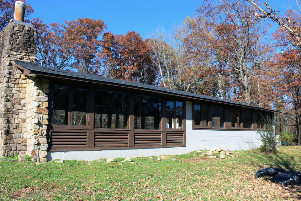 This 2021 photo shows library building of Highlander Folk School in New Market, Tenn. A fight is brewing in Tennessee over the legacy of a legendary social justice school that counts Rosa Parks among its alumni and Eleanor Roosevelt among its supporters. One of the few buildings left is the Highlander library. Preservationists restored the building and want it listed on the National Register of Historic Places. But the Highlander Research and Education Center never stopped working from a new location. (David Currey via AP)