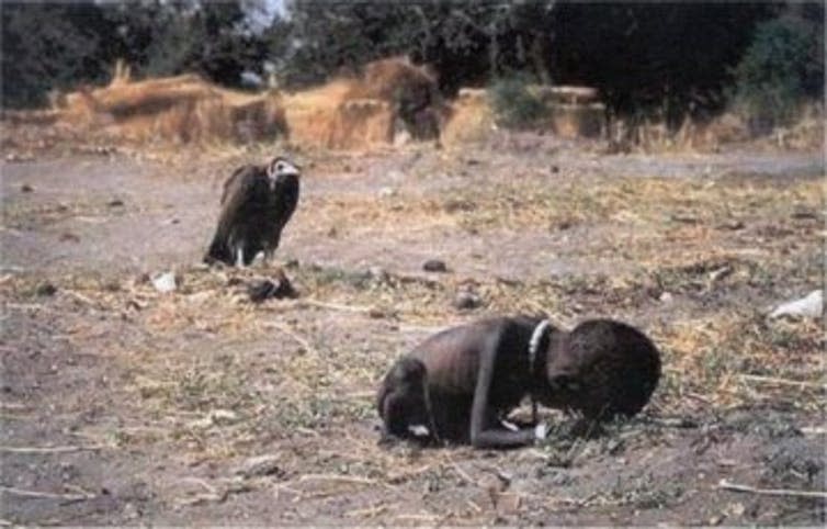 Starving Sudanese child with vulture in background.