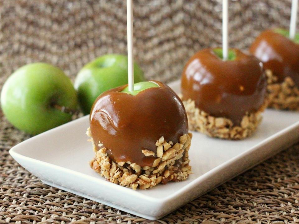 <p>Melissa Sperka</p><p>Legend has it that <a href="https://parade.com/224587/reedrummond/caramel-apple-pie/" rel="nofollow noopener" target="_blank" data-ylk="slk:caramel apples;elm:context_link;itc:0;sec:content-canvas" class="link ">caramel apples</a> were created by Dan Walker, a sales representative for Kraft during the 1950s. Not surprisingly, when Kraft began printing Walker’s genius recipe on bags of their individually wrapped caramels, sales skyrocketed. We may never know who first dipped an apple into a pot of melted caramel, but they are still popular today. Now you can find this tasty traditional Halloween <span>candied apple</span> dipped in an endless variety of additional toppings, from crushed Oreos to chocolate chips to marshmallows.</p><p><strong>Related: <a href="https://parade.com/345338/melissasperka/the-perfect-homemade-caramel-dipped-apples/" rel="nofollow noopener" target="_blank" data-ylk="slk:Step-by-Step Instructions for Make Caramel Apples at Home;elm:context_link;itc:0;sec:content-canvas" class="link ">Step-by-Step Instructions for Make Caramel Apples at Home</a></strong></p>