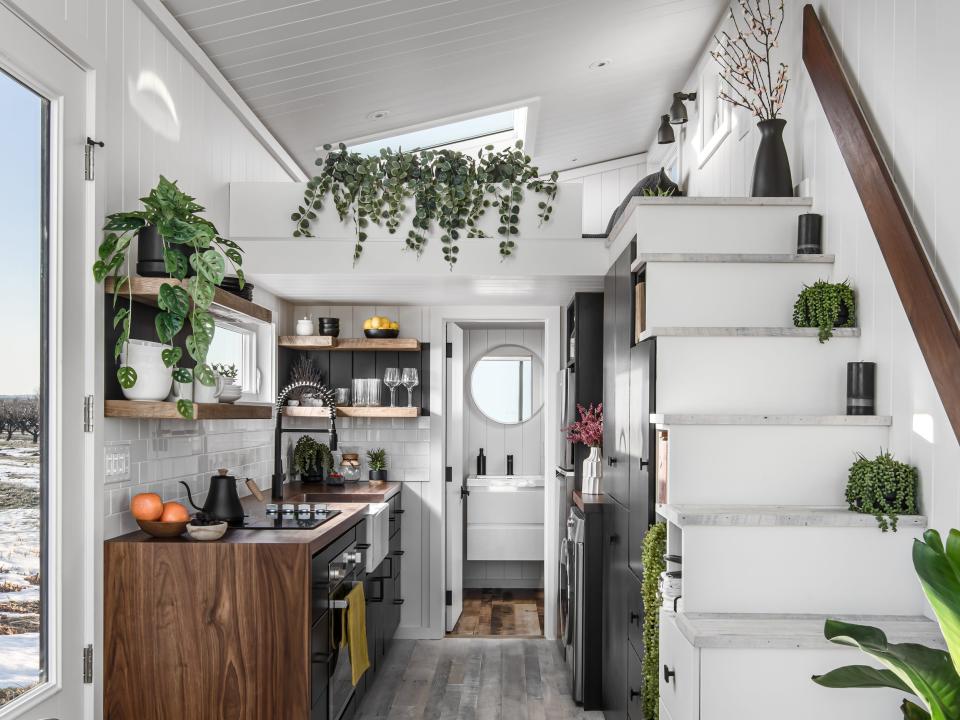 the kitchen space in front of the bathroom next to the staircase