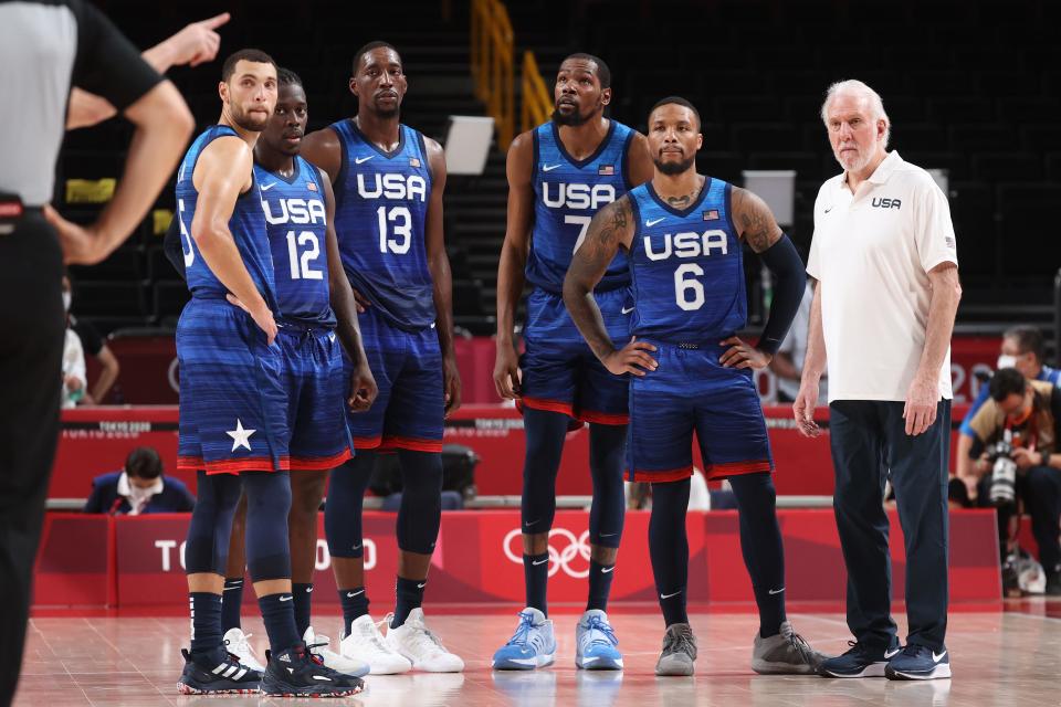 Head Coach Gregg Popovich, right, and members of the U.S. men's basketball team look on in disbelief during their loss to France in the opening game of the Tokyo Olympics.