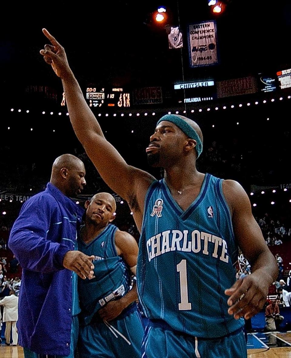 Charlotte Hornet’s Baron Davis celebrates with teammates ELden Campbell and David Wesley after the Hornets beat the Orlando Magic 100-110 in overtime during Game 3 of the Eastern Conference Playoffs on April 27, 2002, at the TD Waterhouse Center in Orlando, FL. Baron Davis had a triple-double and finished with 33-points. PATRICK SCHNEIDER/Charlotte Observer