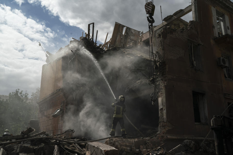 A firefighter works to extinguish a fire after a Russian attack that heavily damaged a residential building in Sloviansk, Ukraine, Wednesday, Sept. 7, 2022. (AP Photo/Leo Correa)