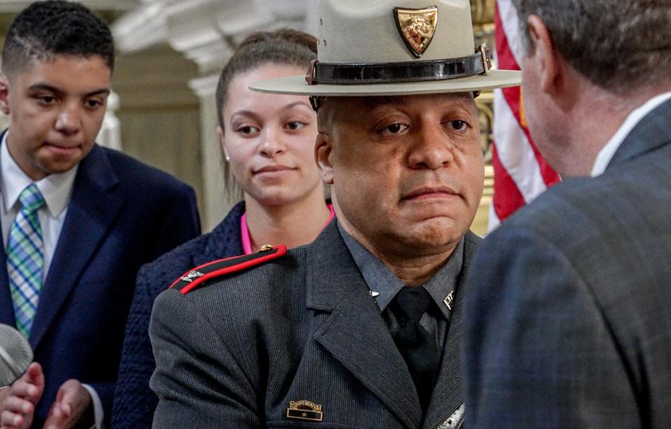 Gov. Dan McKee swears in Darnell S. Weaver as superintendent of the Rhode Island State Police earlier this spring at the State House. Behind Weaver are his son, Chase, and daughter, Maleah.