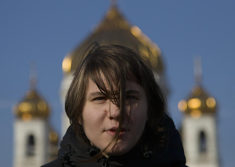 Member of the Pussy Riot punk band Yekaterina Samutsevich, in front of the Christ the Savior Cathedral, a year after their performance, in Moscow, Russia, Thursday, Feb. 21, 2013. (AP Photo/Ivan Sekretarev)