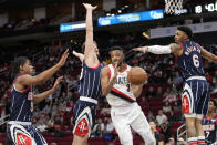 Portland Trail Blazers guard CJ McCollum (3) loos to pass as Houston Rockets guard Josh Christopher (9), center Alperen Sengun, left, and forward Kenyon Martin Jr. (6) defend during the first half of an NBA basketball game, Friday, Jan. 28, 2022, in Houston. (AP Photo/Eric Christian Smith)