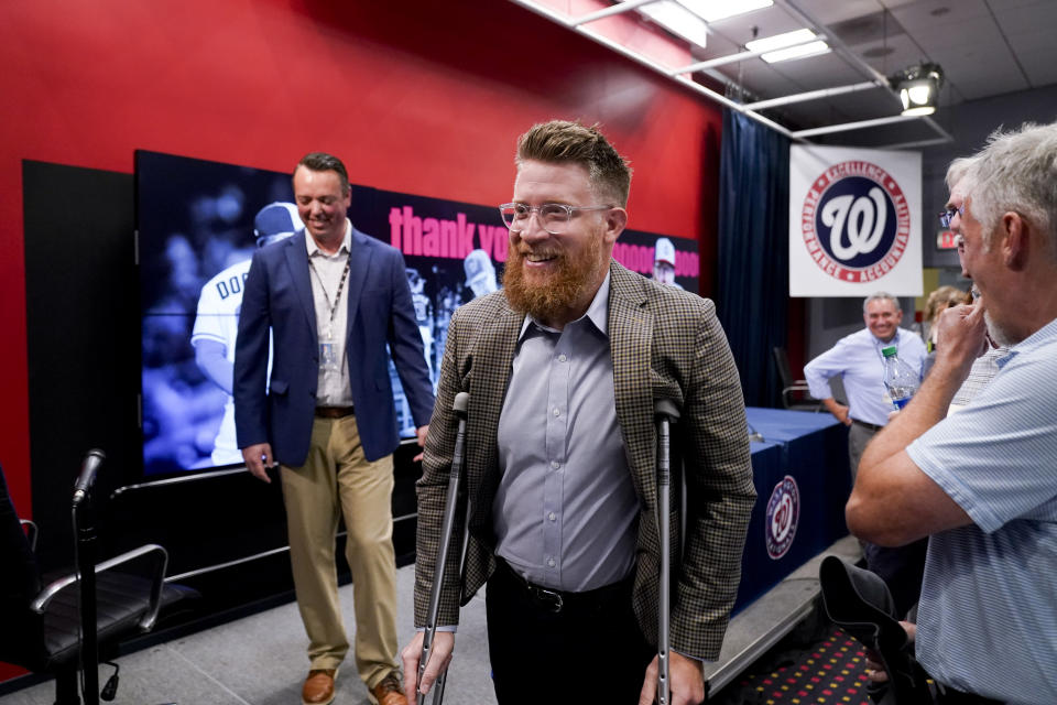 Washington Nationals relief pitcher Sean Doolittle, center, departs after speaking at a news conference after announcing his retirement at Nationals Park, Friday, Sept. 22, 2023, in Washington. Doolittle has decided to retire from baseball after more than a decade pitching in the majors that included helping the Nationals win the World Series in 2019. (AP Photo/Andrew Harnik)