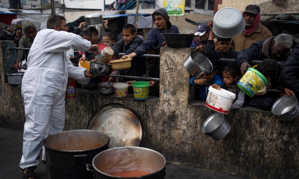 <span>Palestinians queuing for food aid in Rafah, Gaza, last month.</span><span>Photograph: Fatima Shbair/AP</span>