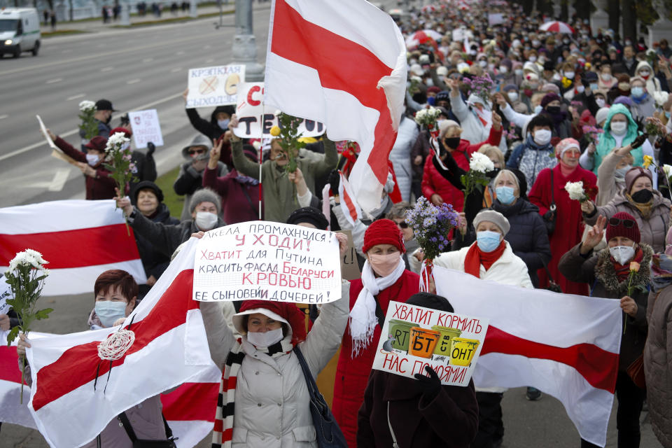 People, most of them elderly women, walk during an opposition rally in Minsk, Belarus, Monday, Oct. 19, 2020. The elderly rallied in Minsk once again on Monday to demand resignation of the country's President Alexander Lukashenko, as mass protests triggered by a disputed election continue to rock Belarus. Lukashenko's older supporters also gathered in the country's capital Monday for a pro-government rally. (AP Photo)