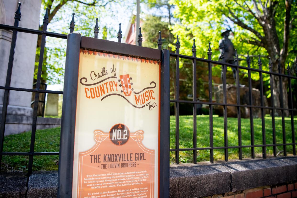 A Cradle of Country Music Tour sign for The Louvin Brothers song "The Knoxville Girl" is displayed outside the Old Knox County Courthouse at the corner of Gay Street and Main Avenue in downtown Knoxville.