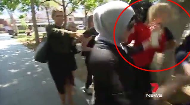 The woman shoved the young reporter. Source: 7News