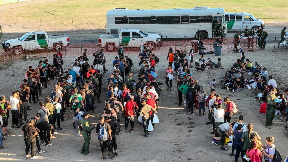 People who crossed the US/Mexico border are held at a border patrol processing center located below th