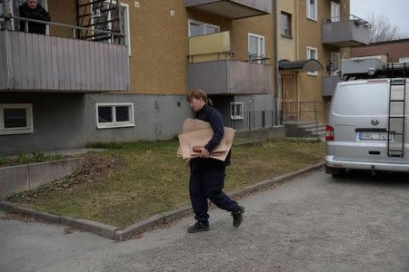 A police officer carries materials from a house search as part of the investigation after the terror attack in Drottninggatan where several people were killed and injured after a truck crashed into a department store Ahlens, in an apartment in Varberg south west of Stockholm, Sweden, April 8, 2017. Maja Suslin/TT News Agency via REUTERS