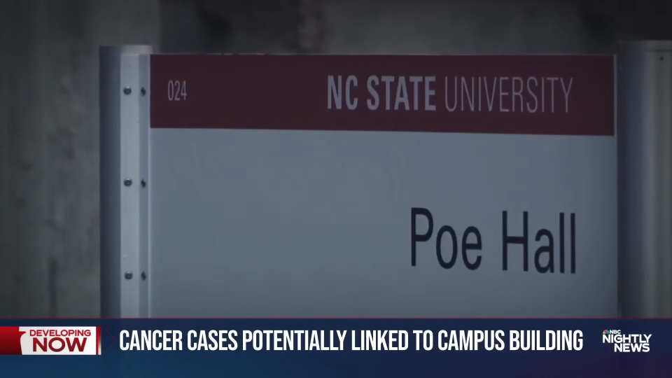 Sign reading "Poe Hall" at NC State University with a news banner about cancer cases possibly linked to a campus building
