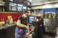 A barista prepares a coffee at a cafe in Melbourne, Australia, Wednesday, Oct. 28, 2020. Australia’s second largest city of Melbourne which was a coronavirus hotspot emerges from a nearly four-months lockdown, with restaurants, cafes and bars opening and outdoor contact sports resuming on Wednesday.(AP Photo/Asanka Brendon Ratnayake)