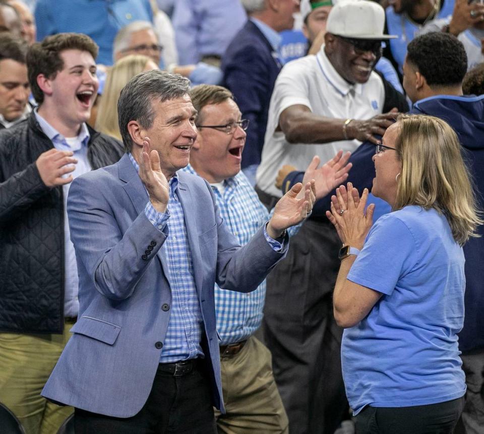 North Carolina Governor Roy Cooper and House Speaker Tim Moore relish in North Carolina’s 81-77 victory over Duke in the NCAA Final Four semi-final on Saturday, April 2, 2022 at Caesars Superdome in New Orleans, La. Robert Willett/rwillett@newsobserver.com