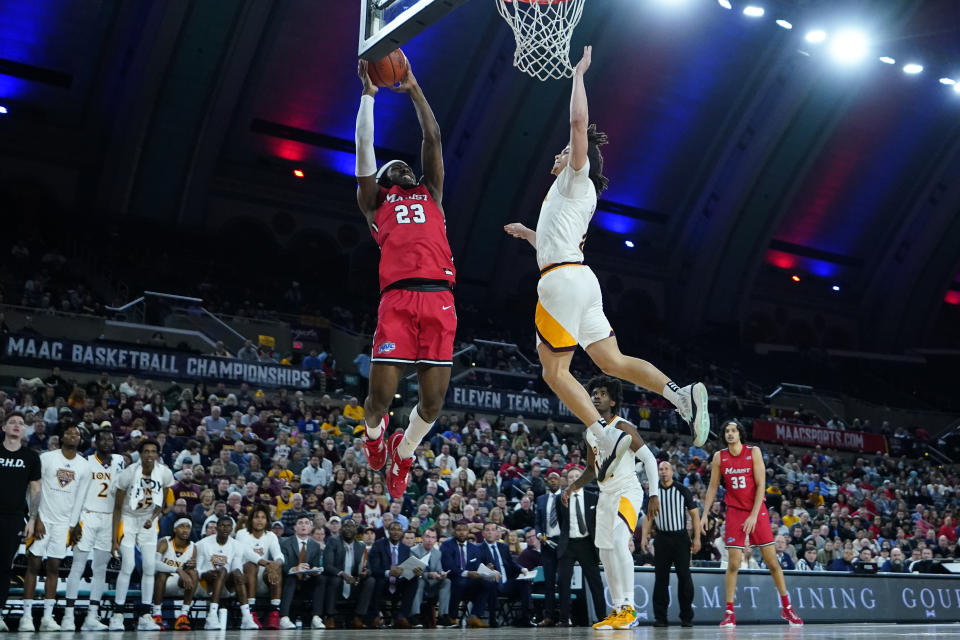 Marist's Javon Cooley (23) goes up for a shot against Iona's Walter Clayton Jr. during the first half of an NCAA college basketball game in the championship of the Metro Atlantic Athletic Conference Tournament, Saturday, March 11, 2023, in Atlantic City N.J. (AP Photo/Matt Rourke)