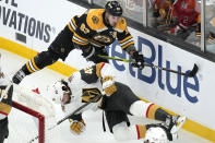 Boston Bruins left wing Brad Marchand drops Vegas Golden Knights defenseman Daniil Miromanov to the ice on a hard check during the first period of an NHL hockey game, Monday, Dec. 5, 2022, in Boston. (AP Photo/Charles Krupa)