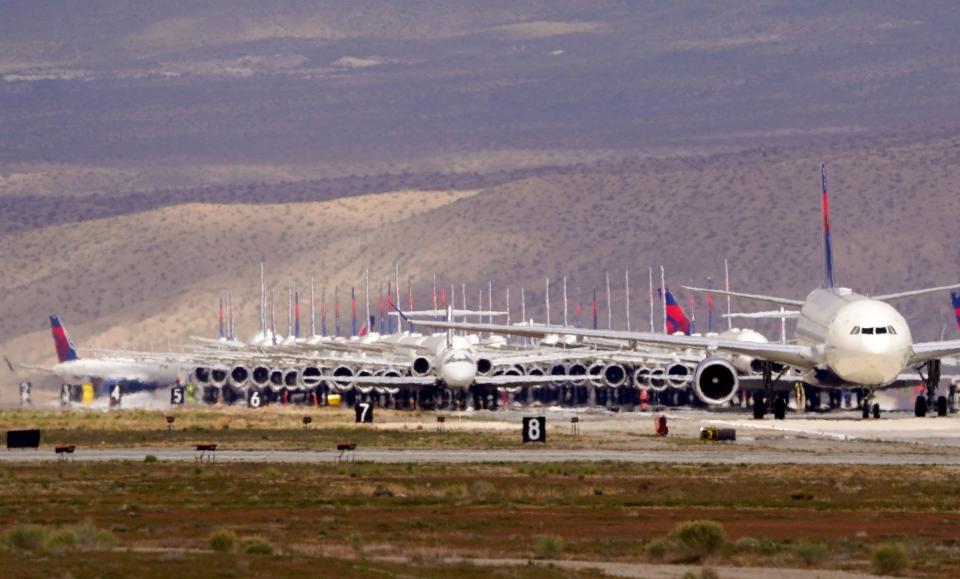 Delta Air Lines aircraft are stored at Southern California Logistics Airport, Wednesday, March 25, 2020, in Victorville, Calif.