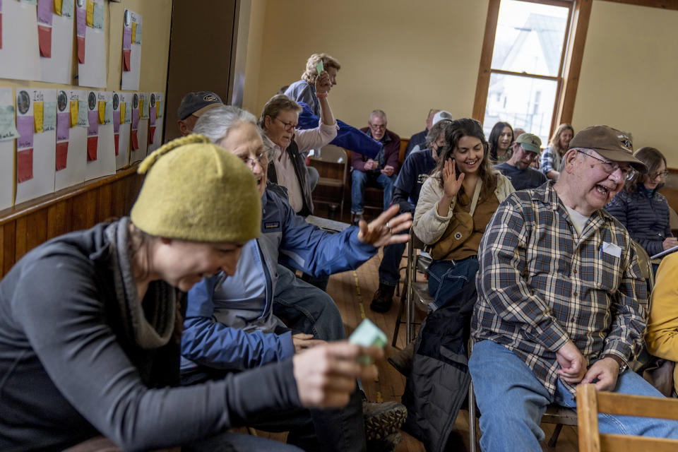 Residents react to the conclusion of the annual Town Meeting in Elmore, Vt., Tuesday, March 5, 2024. Elmore's Town Meeting has been going for nearly four hours. What has unfolded represents a cross-section of democracy, of people choosing for themselves how to live and work and govern. (AP Photo/David Goldman)