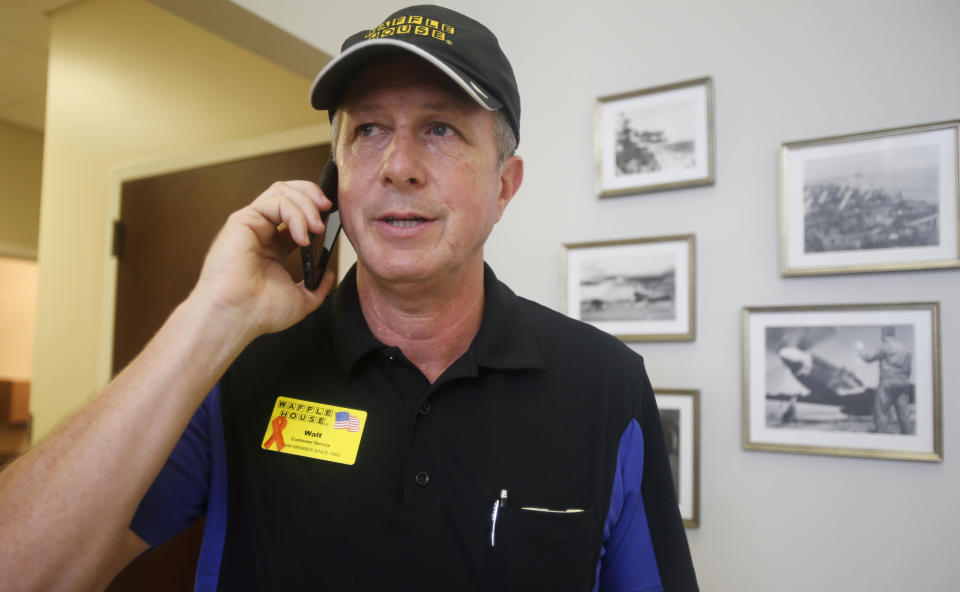 FILE - Walt Ehmer, president and CEO of Waffle House, speaks on the phone after landing at the Wilmington airport with an emergency response team in Wilmington, N.C., Sept. 17, 2018. (AP Photo/Steve Helber, File)