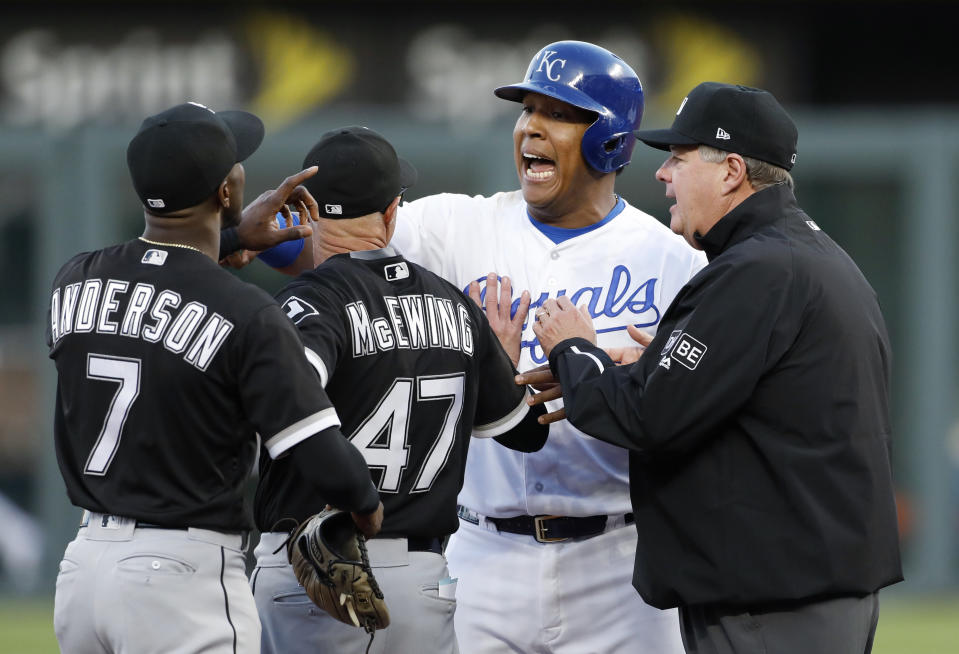 Chicago White Sox bench coach Joe McEwing separates shortstop Tim Andersonfrom Kansas City Royals’ Salvador Perez at second base after an exchange of words causing the benches to clear. (AP Photo)